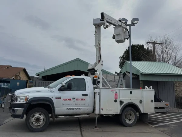 Floener Electric technician servicing a commercial business sign from a bucket truck in Spokane, WA